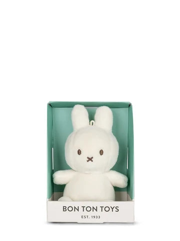 A white plush bunny toy is displayed in a green box with the text "BON TON TOYS EST. 1933".
