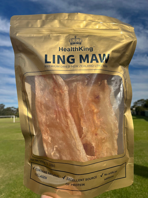 A hand holding a package of dried meat, specifically "LING MAW", which is a type of dried chicken.
