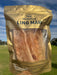 A hand holding a package of dried meat, specifically "LING MAW", which is a type of dried chicken.