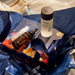 A collection of beauty products, including a bottle of Jurlique, a bottle of Jurlique, and a small bottle, are arranged on a blue background with a floral pattern.