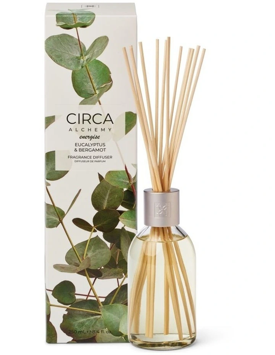 a glass diffuser with a clear glass jar filled with eucalyptus and bergamot essential oil, along with a box of the product.