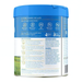 The image is a blue can with text and images, including a grassy field and a blue sky.