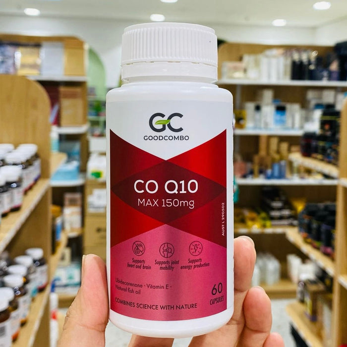 A hand holding a bottle of Goodcomb Co Q10 vitamin supplement.
