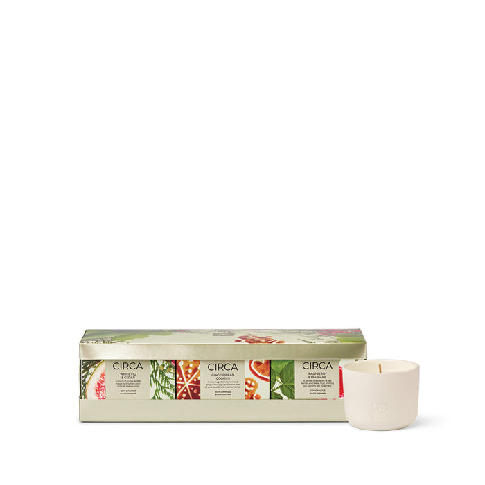 a set of candles in a box, with a single candle placed next to the box.