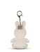A white plush rabbit toy with a metal tag attached to it.
