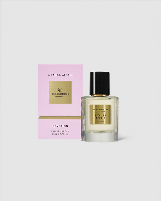 a perfume bottle and its packaging, both of which are pink in color.