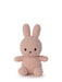 A pink, furry stuffed bunny toy is sitting on a white background.