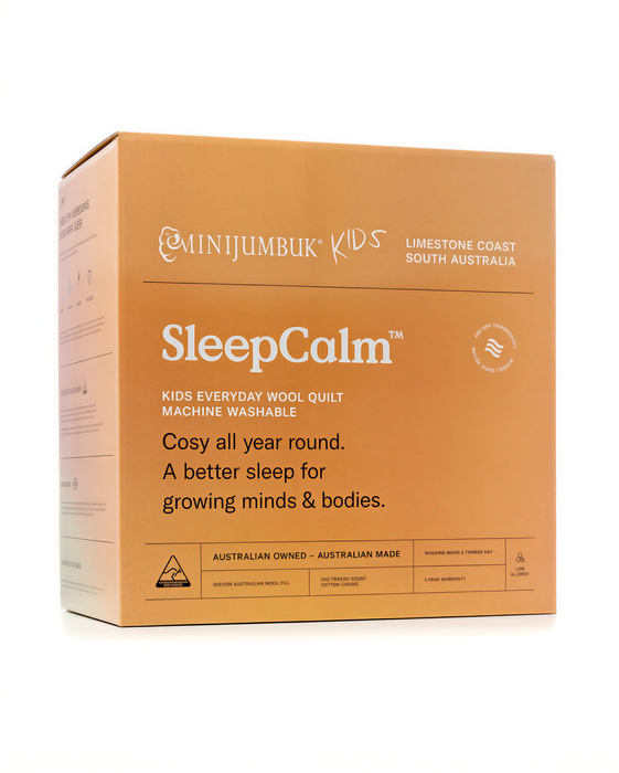 The image is a cardboard box for a product called "SleepCalm", which is a kids' quilt made of wool.