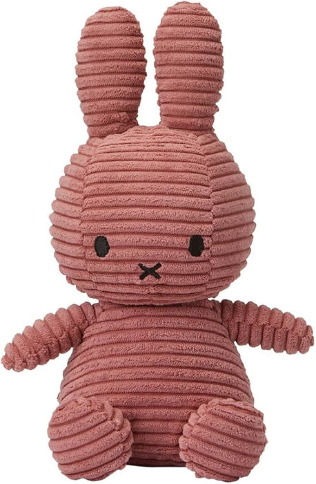 A pink, furry stuffed rabbit toy with large ears and a black mouth.