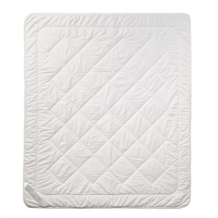 a white quilted blanket or comforter, which appears to be a bedding item.