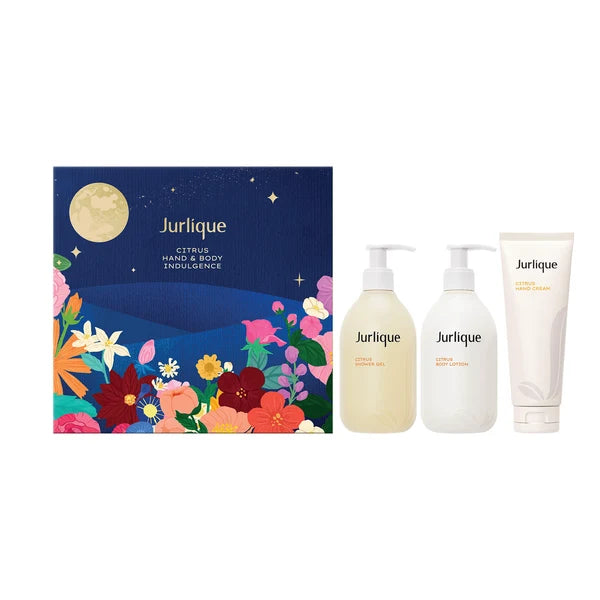 A set of three beauty products from the brand Jurique, including a body lotion, a body cream, and a body oil, arranged next to a box with a floral design.