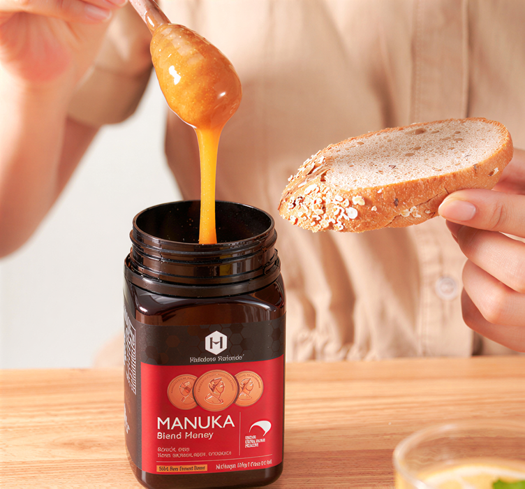 A person is pouring honey from a jar into a glass, with a slice of bread in their hand.