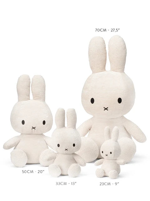 A collection of four white stuffed rabbits of different sizes, ranging from 50 cm to 23 cm in height.