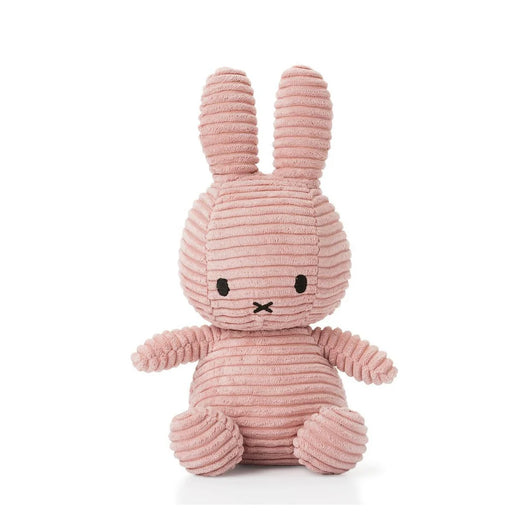 A pink, striped stuffed bunny toy is sitting on a white surface.