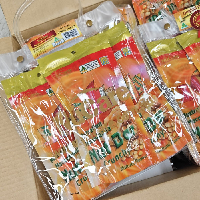 A cardboard box containing several clear plastic bags filled with what appears to be a type of snack or food product.