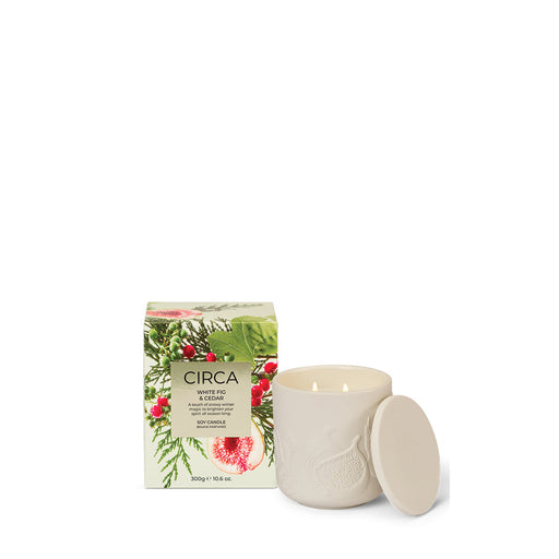 A white ceramic candle with a lid and a box with a floral design are shown against a white background.