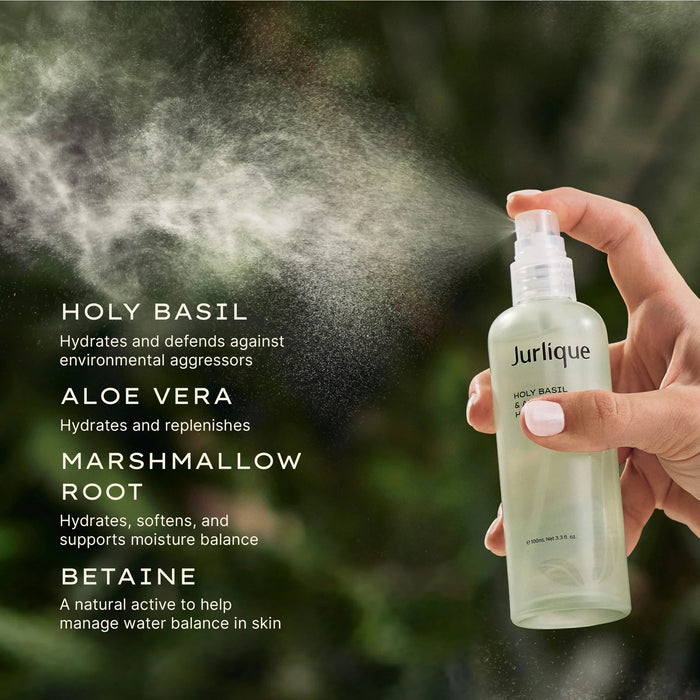 Hand holding a spray bottle of Jurlique products, including Holy Basil, Aloe Vera, Marshmallow Root, and Etaine.