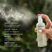 Hand holding a spray bottle of Jurlique products, including Holy Basil, Aloe Vera, Marshmallow Root, and Etaine.