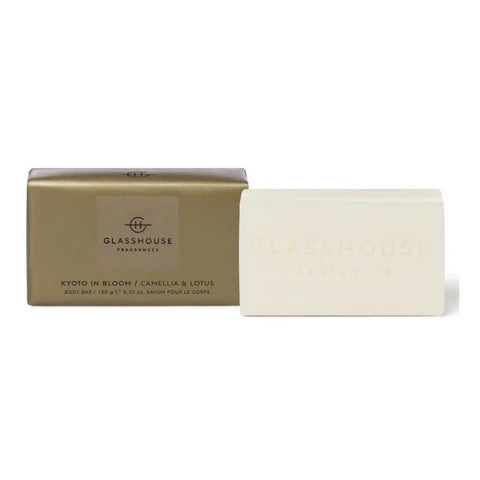 A gold-colored box and a white rectangular bar of soap are shown against a white background.