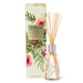 a white box with a design of pine branches and pine cones, and a clear glass vase with wooden sticks inside, both placed next to each other.