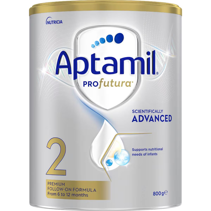 A can of Aptamil Pro Futura, a powdered infant formula, with the product number and nutritional information displayed.