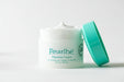 A jar of Pearl Cream, a 24-hour release anti-aging cream, with a green lid and a white body.