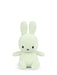 A light green plush bunny toy with black eyes and mouth.