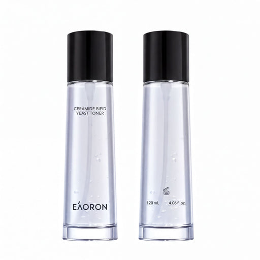 two bottles of a clear liquid, possibly a toner or facial cleanser, with black caps and branding.