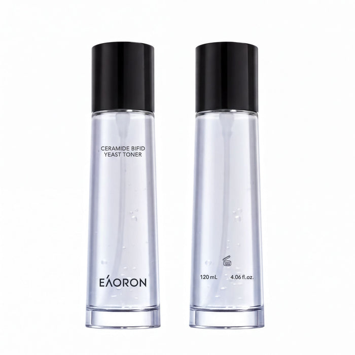 two bottles of a clear liquid, possibly a toner or facial cleanser, with black caps and branding.