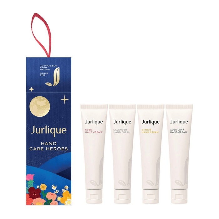 A set of four Jurlique hand care products, including a hand cream, hand lotion, hand cream, and hand cream, presented in a blue and gold packaging with a red ribbon.