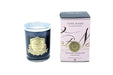 a dark glass candle with a gold label and a pink box with gold lettering, both of which are part of the Côte Noire Collection.