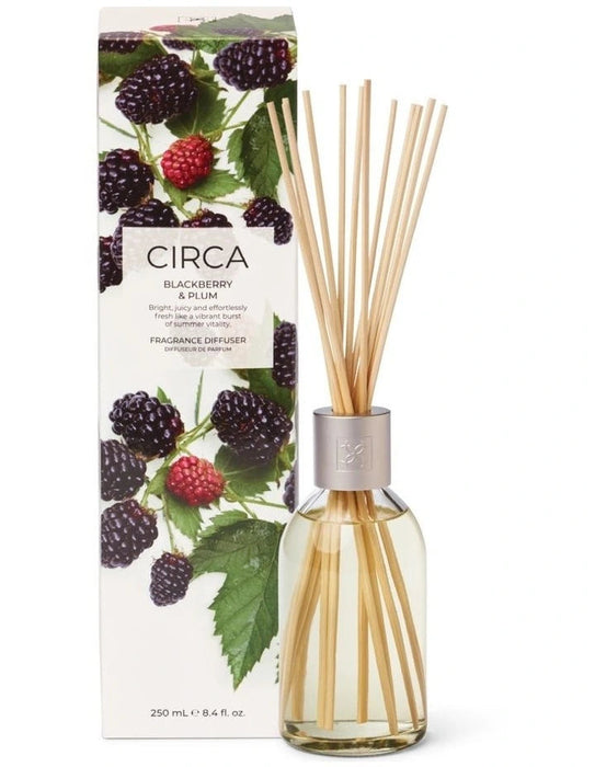 a glass diffuser with a clear glass jar filled with blackberry and plum-scented oil, accompanied by its packaging box.
