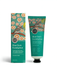 two tubes of hand cream, one standing upright and the other lying on its side, both with a green and orange color scheme.